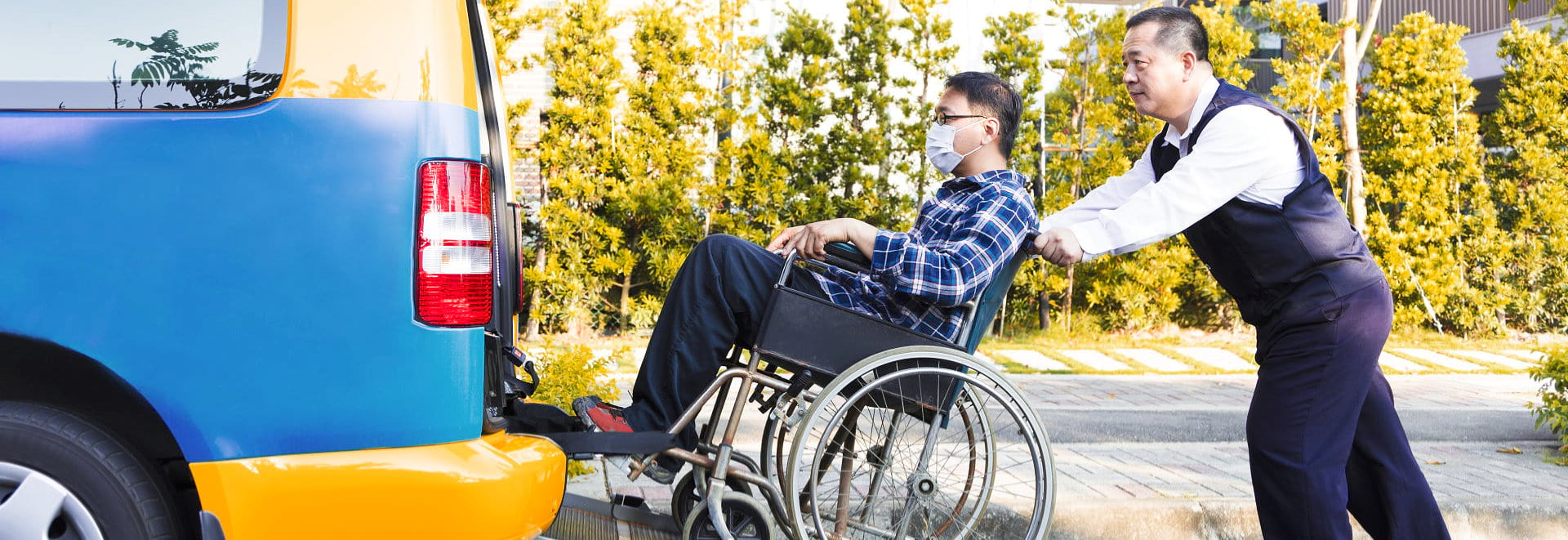 driver helping man in a wheelchair